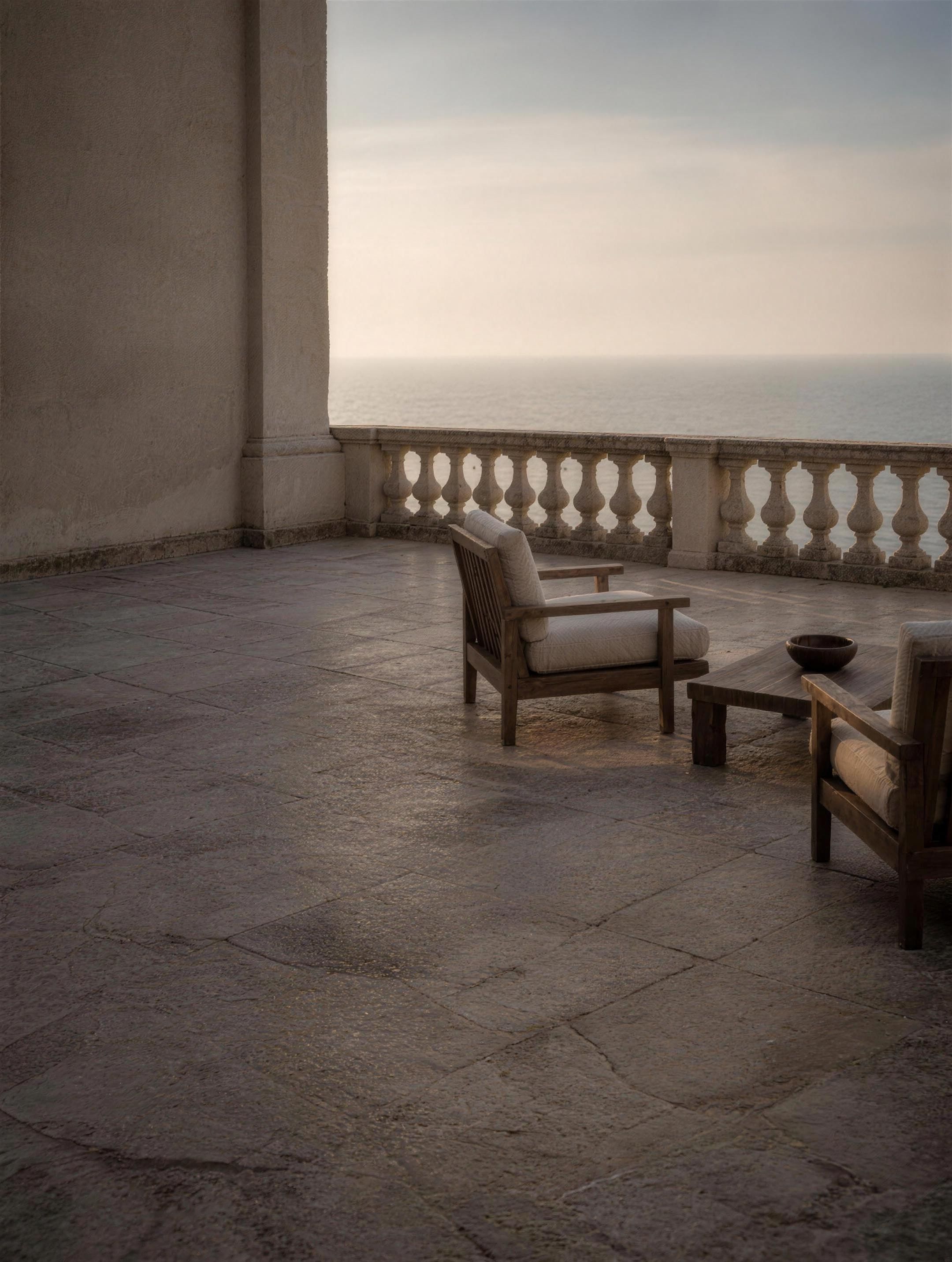 Atmosphere image — a deserted stone terrace at first light, a balustrade and sea mist beyond.